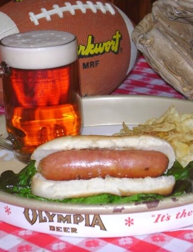 Bratwurst with a mug of beer and football ball