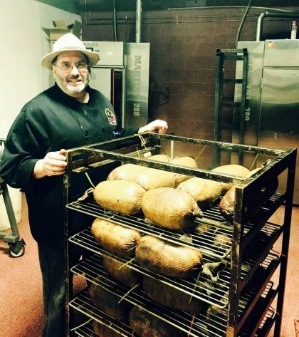 Mike the Wurstmeister pushing hams on a trolley