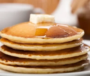 Pancakes with honey and sugar on top