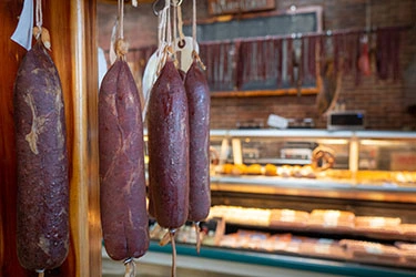 Hermann Wurst Haus Smocked Meat hanging in store shelf