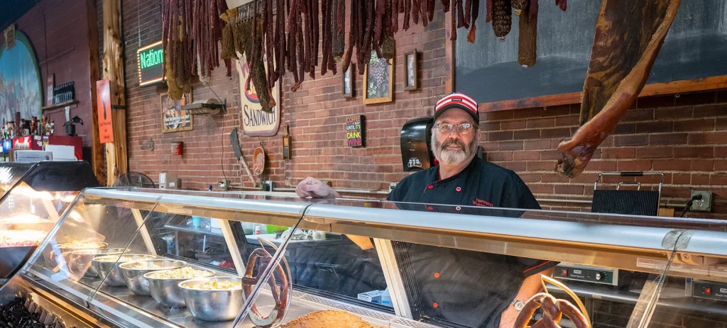 Mike The Wurstmeister selling meats in the store